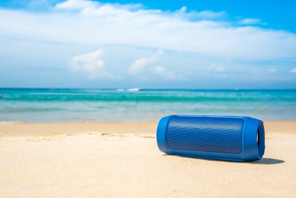 bluetooth speaker blue on the beach sea sand